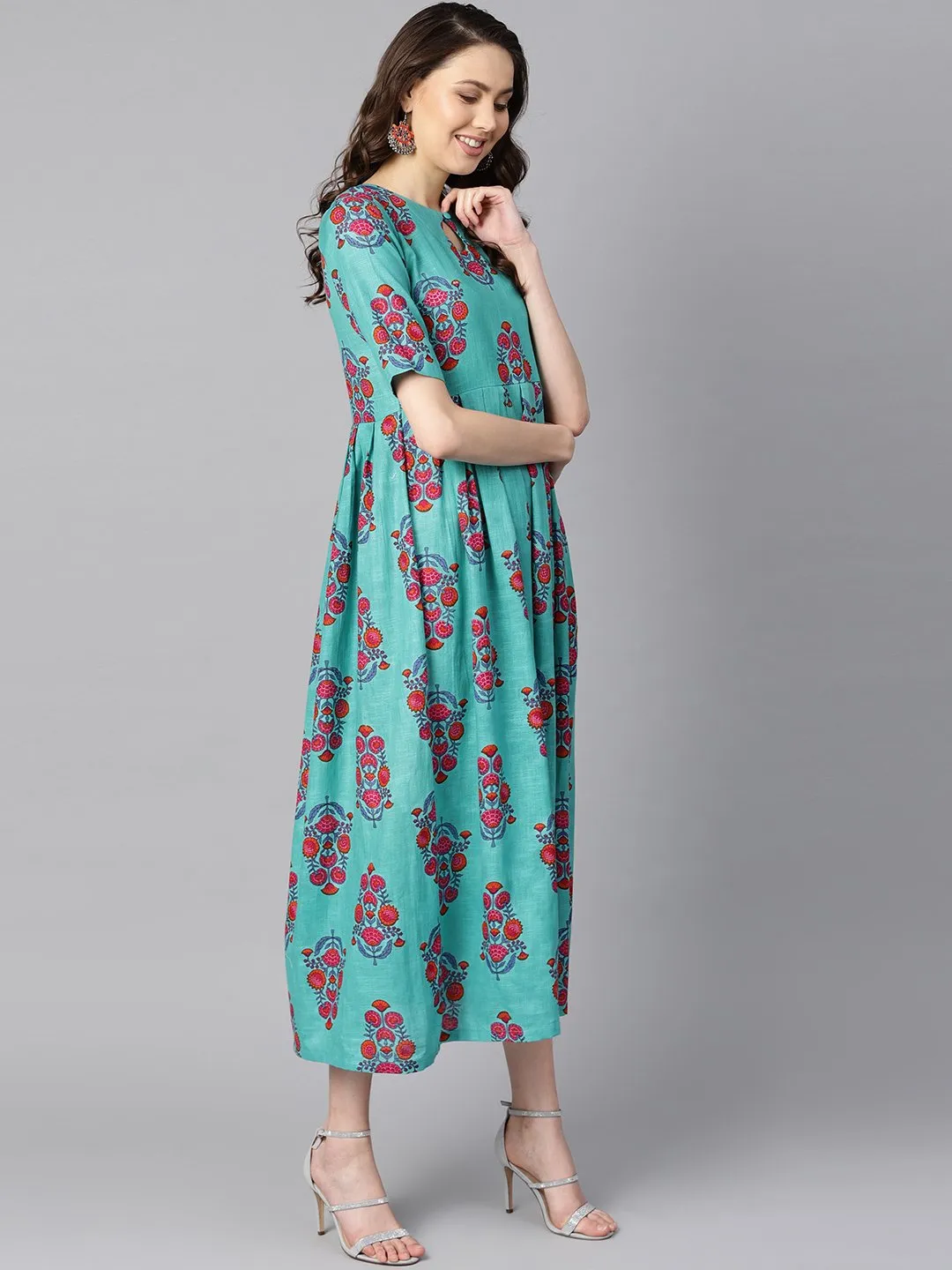 Turqish Blue Color Printed Half Sleeve Pleated Maxi Dress With Deep Back And Tassel Detailing.